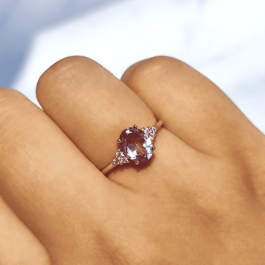 Rose gold vermeil amethyst ring on finger with small pave-style accents