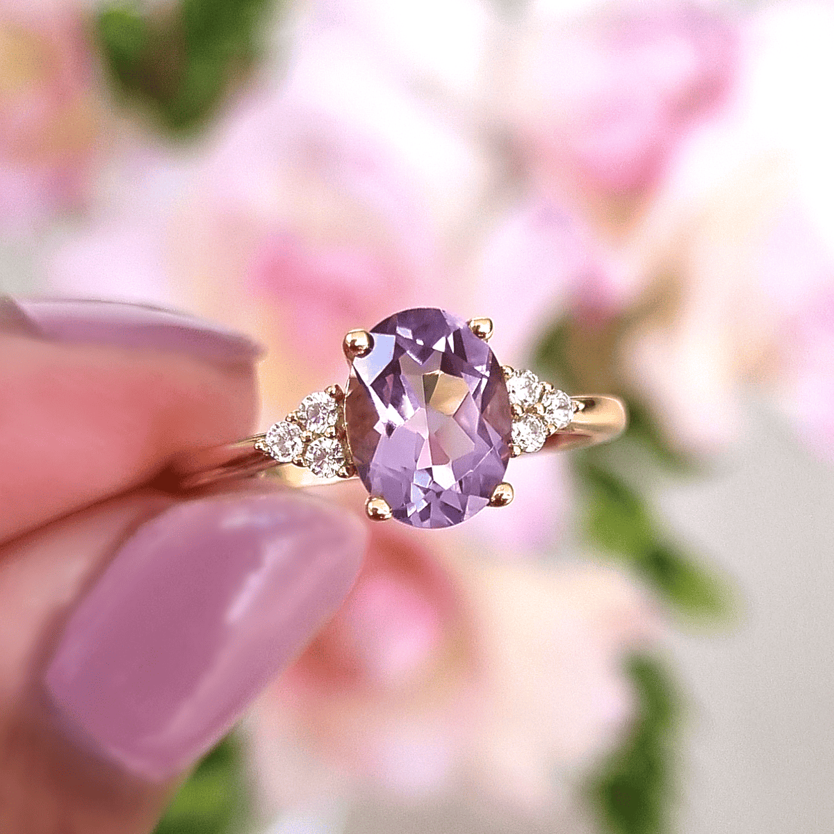 Lavender amethyst solitaire ring with gold prongs and clustered clear stones