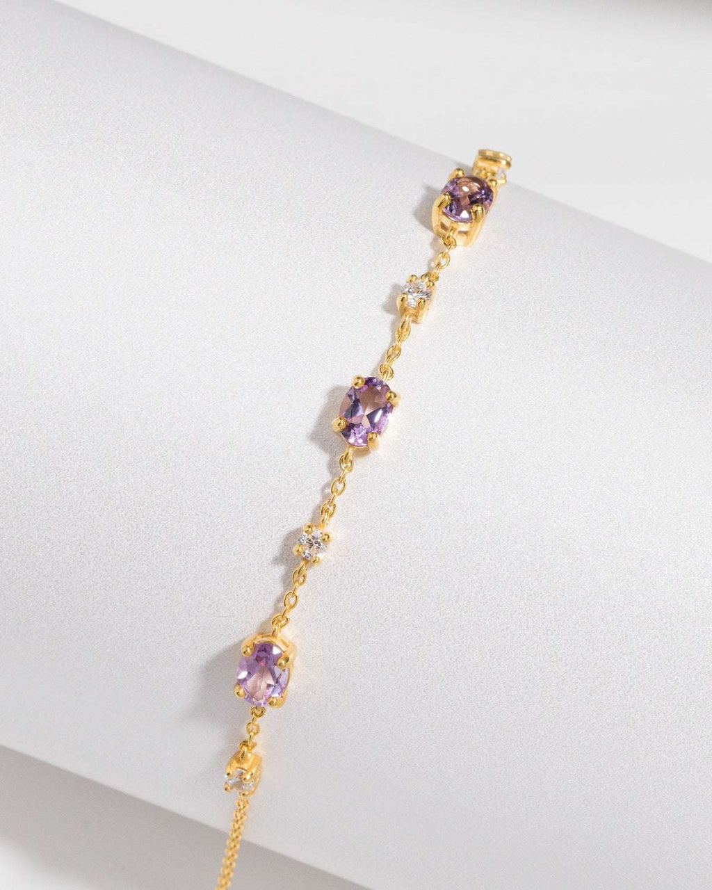 Gold vermeil bracelet with repeating purple gemstone stations.