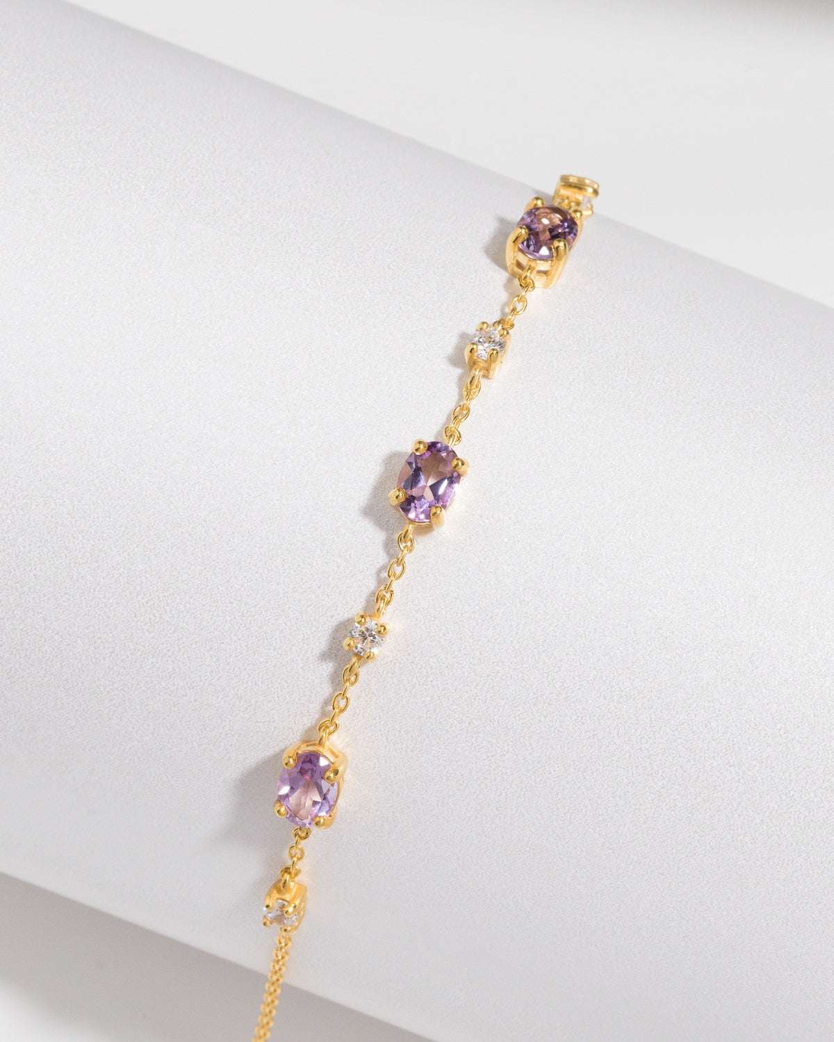 Gold vermeil bracelet with repeating purple gemstone stations.