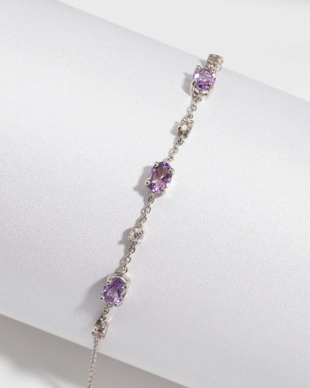 Sterling silver amethyst bracelet with linked chain and oval purple gemstone stations