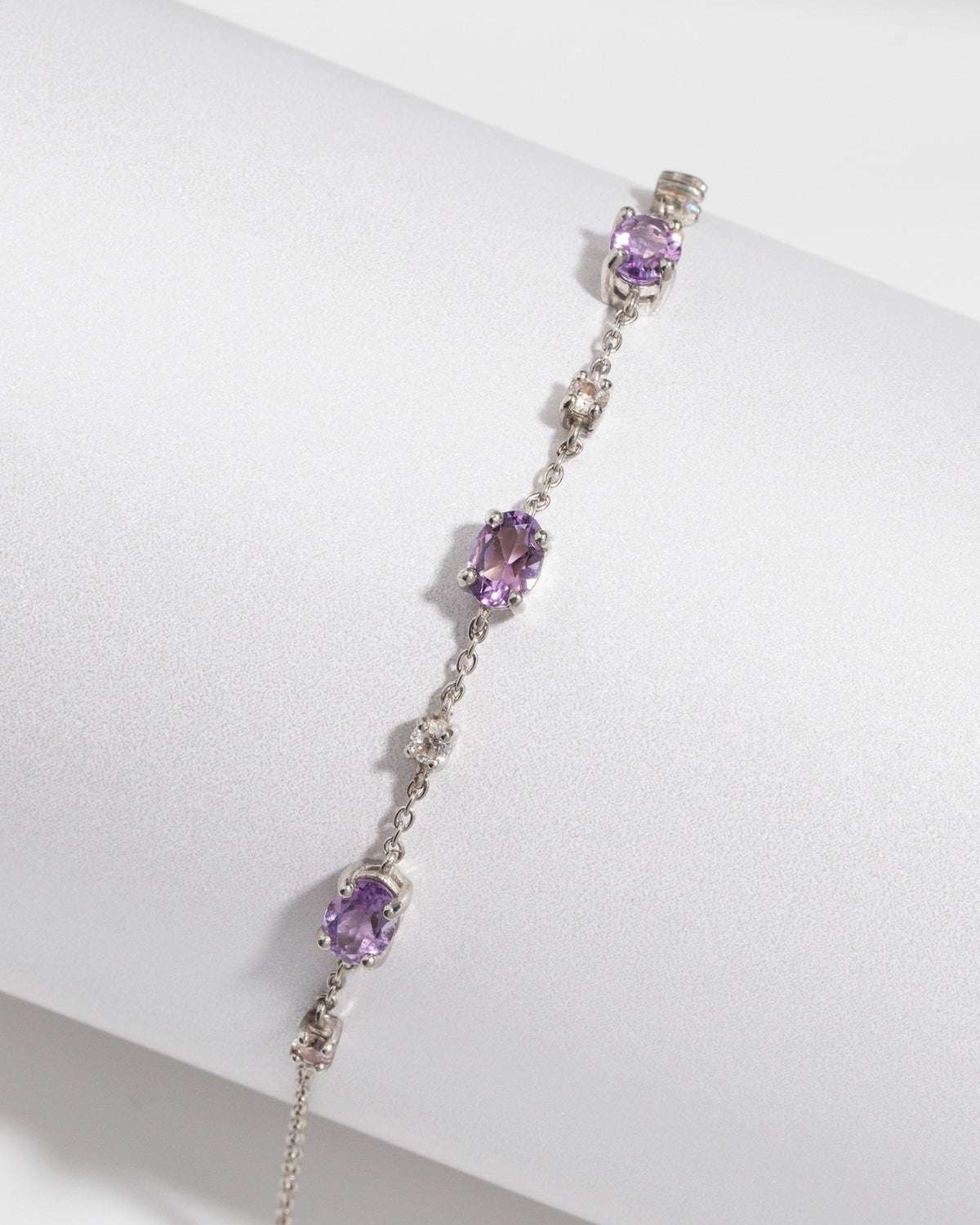 Sterling silver amethyst bracelet with linked chain and oval purple gemstone stations