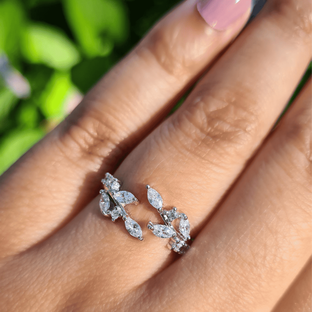 Sterling silver adjustable leaf ring with marquise-cut sparkle stones on finger