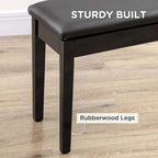 Black piano bench stool with sturdy wooden legs and padded top