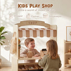 Wooden kids play shop with striped awning where children play at the checkout counter