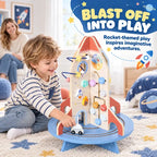 Rocket-themed wooden activity cube with bead maze and wheels, toddler playing