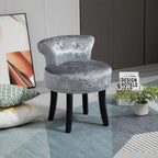 Grey round vanity stool with tufted seat and curved backrest, studded border, black legs