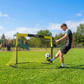 Yellow portable football goal with white netting and black legs, side view on grass