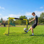 Yellow portable football goal with white netting and black legs, side view on grass