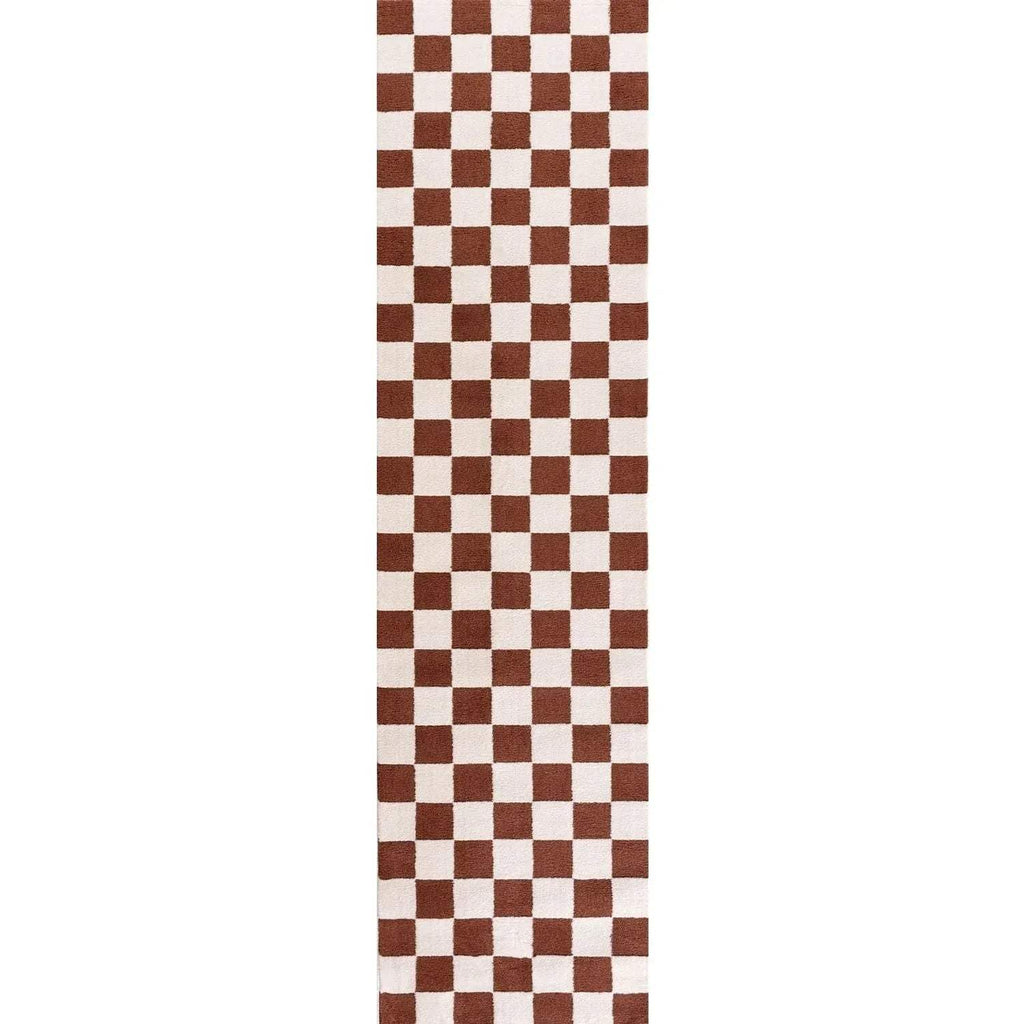 Narrow view of brown and white checkerboard rug with straight vertical edge.