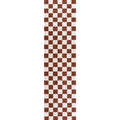 Narrow view of brown and white checkerboard rug with straight vertical edge.