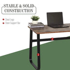 Industrial desk with black steel legs and support bar under rustic brown wood top