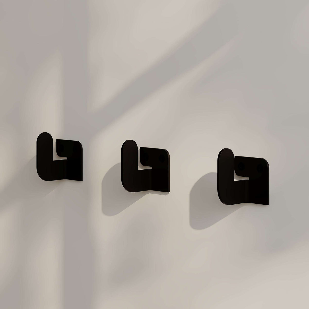 Three black metal hook hangers with square backplates for wall mounting