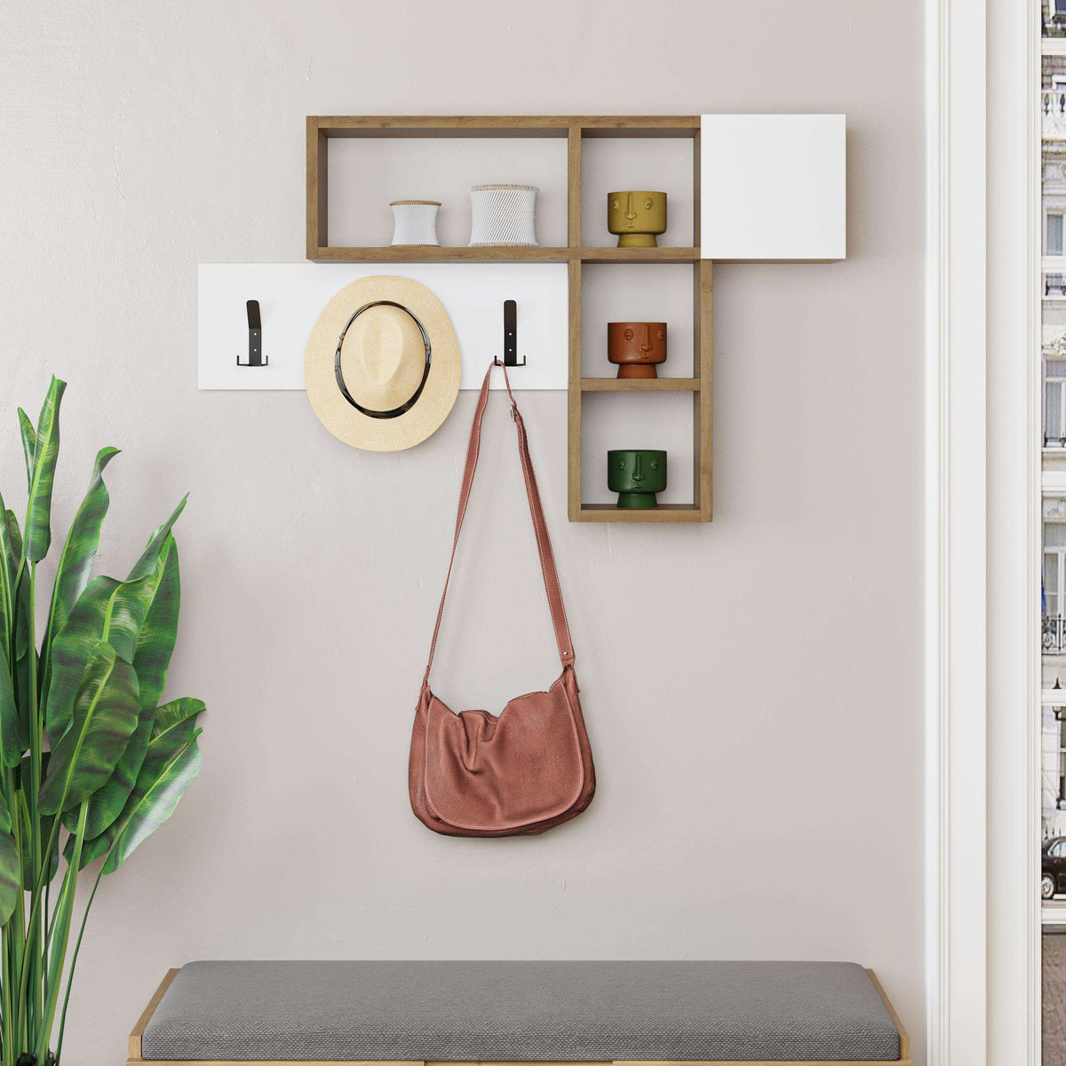 Wall-mounted game hanger with light gray shelves, open cubbies, and three black coat hooks; hat and bag.