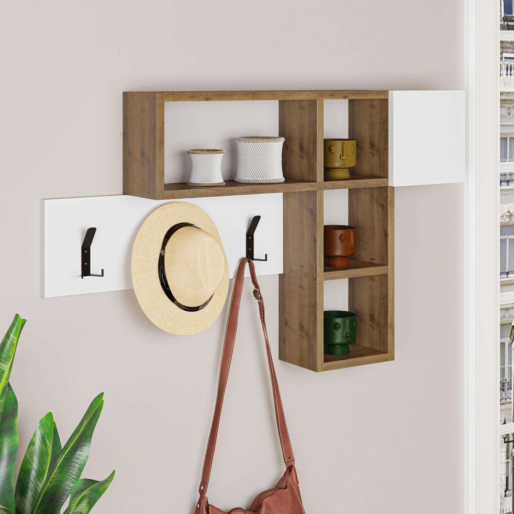 Wall-mounted game hanger with wood-effect shelves, open cubbies, and three black coat hooks; hat and bag.