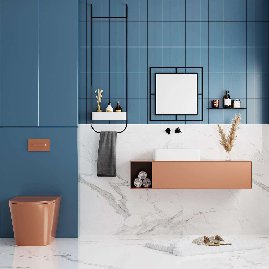Square wall mirror with gold-toned frame and reflective glass on a tiled wall.