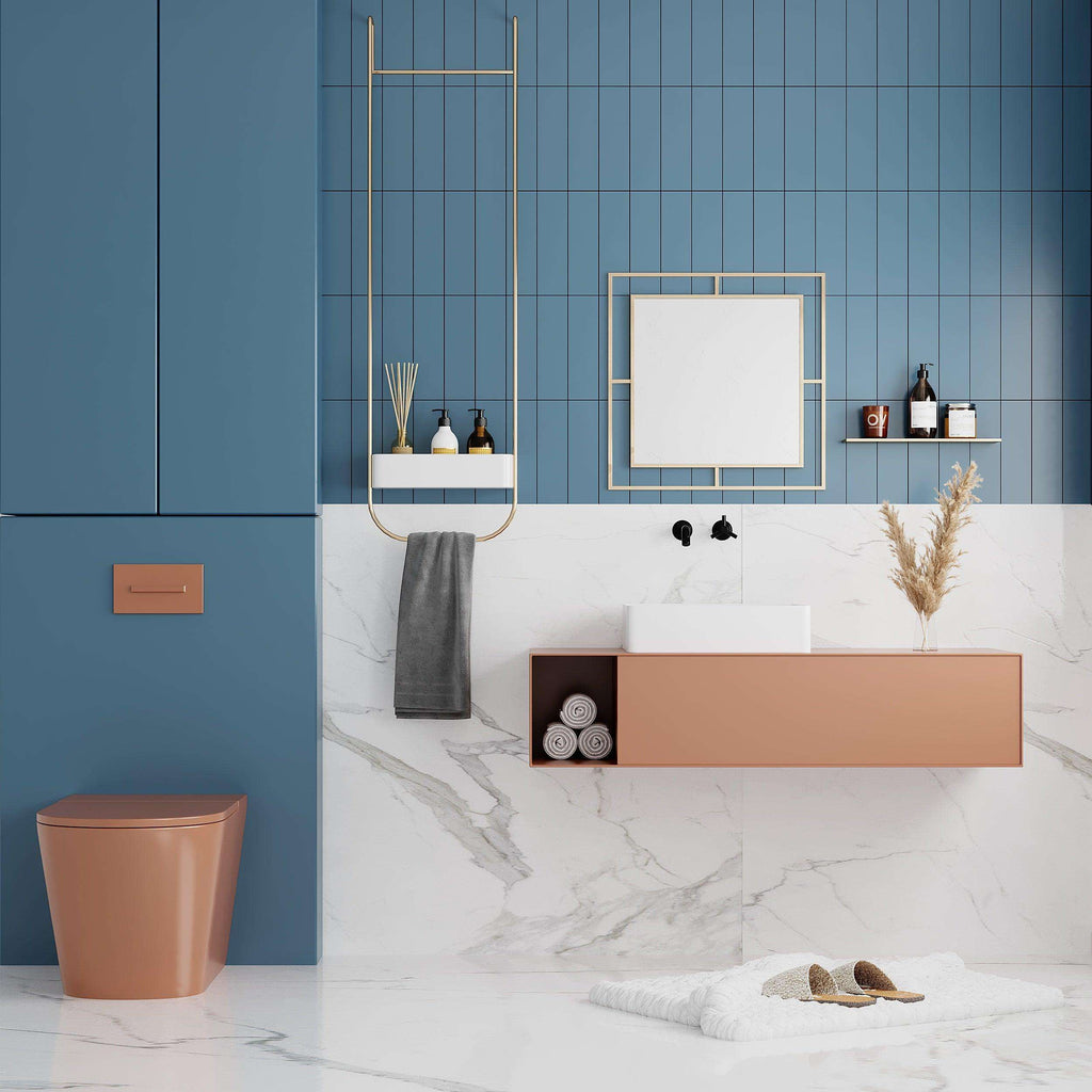 Square wall mirror with gold-toned frame and reflective glass in a bathroom setting.