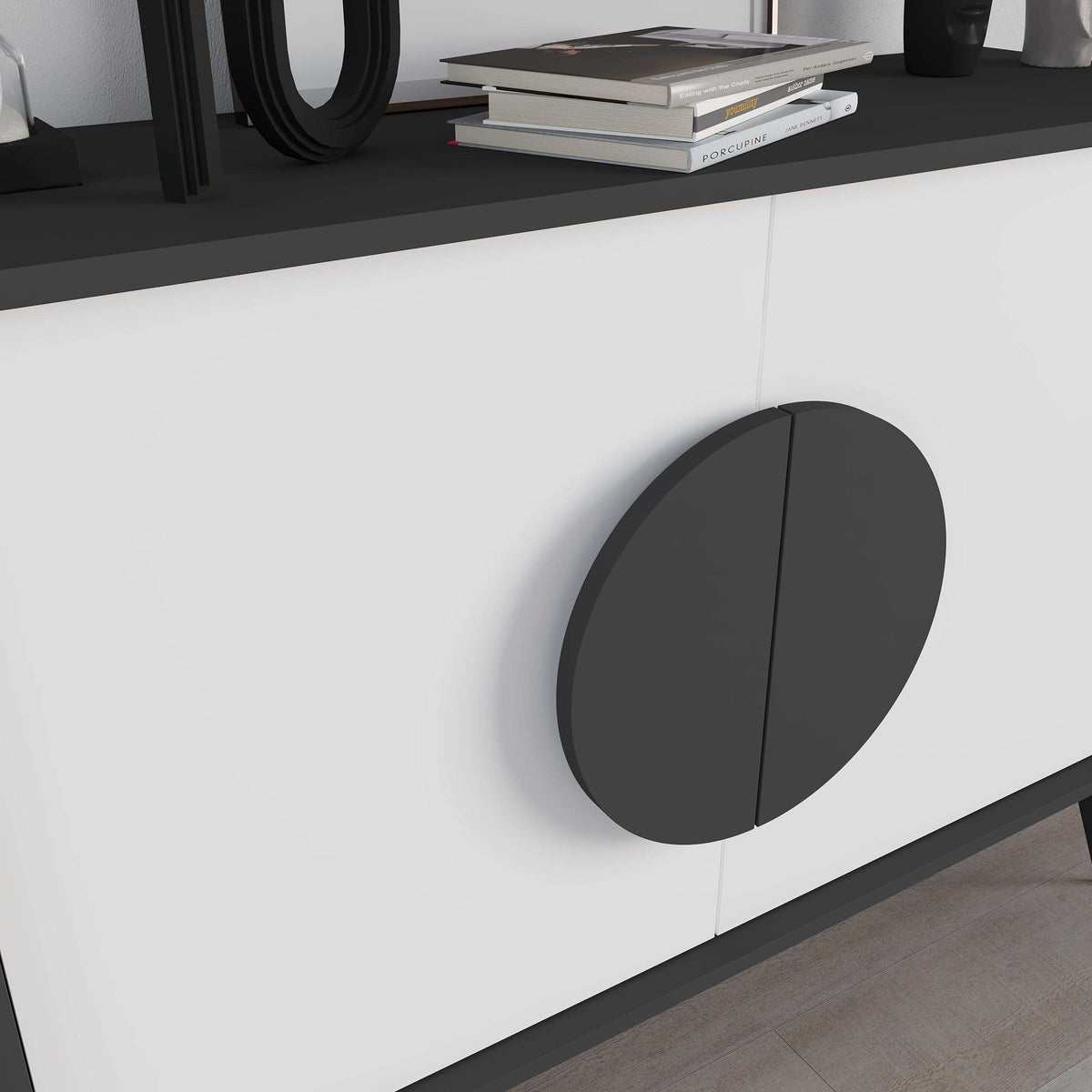 Close-up of modern sideboard front with dark circular knob on white door