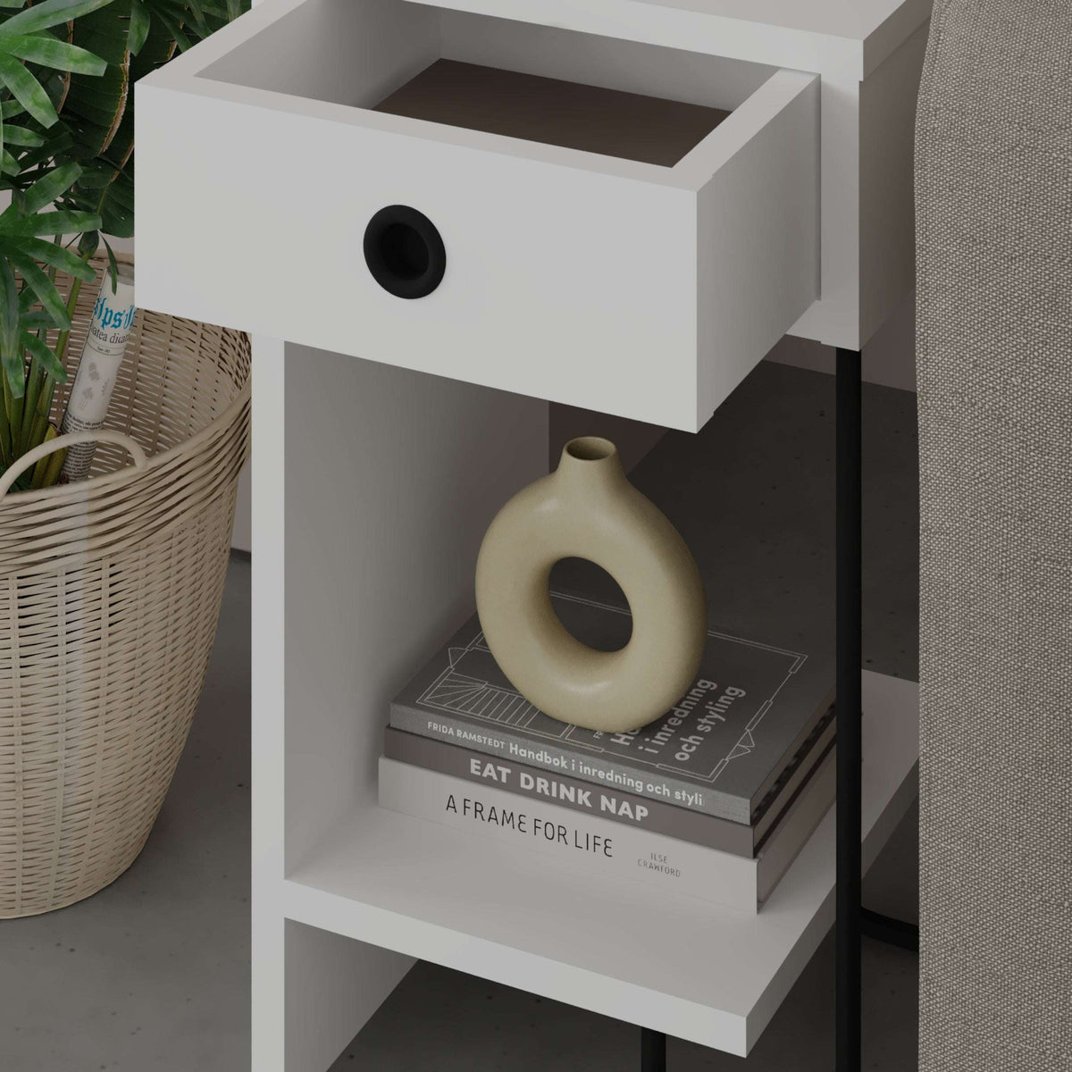 White bedside table module with round pull drawer and open lower shelf, black frame