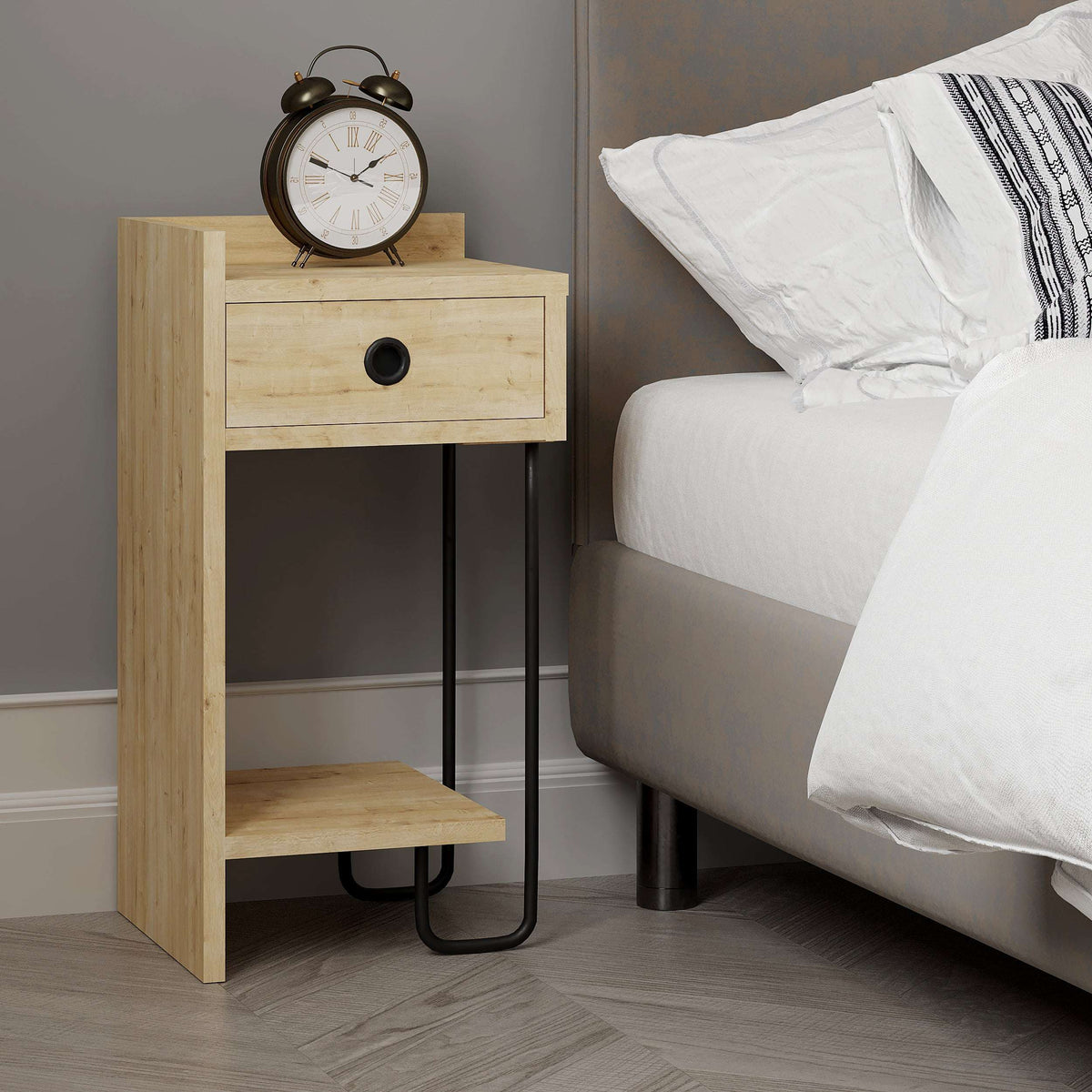 Light oak bedside table with round-pull drawer and open shelf beside bed