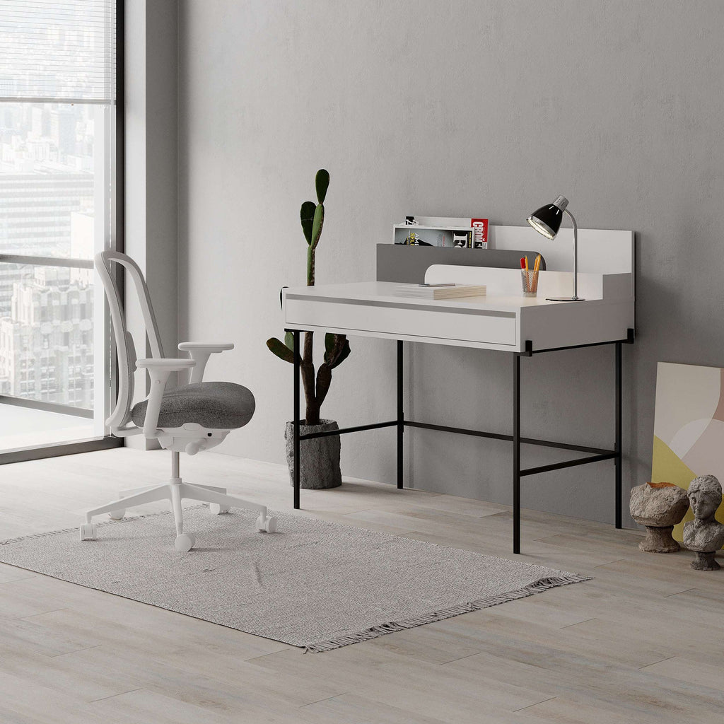 Modern study desk with white top, anthracite base, open cubby shelves, and drawer