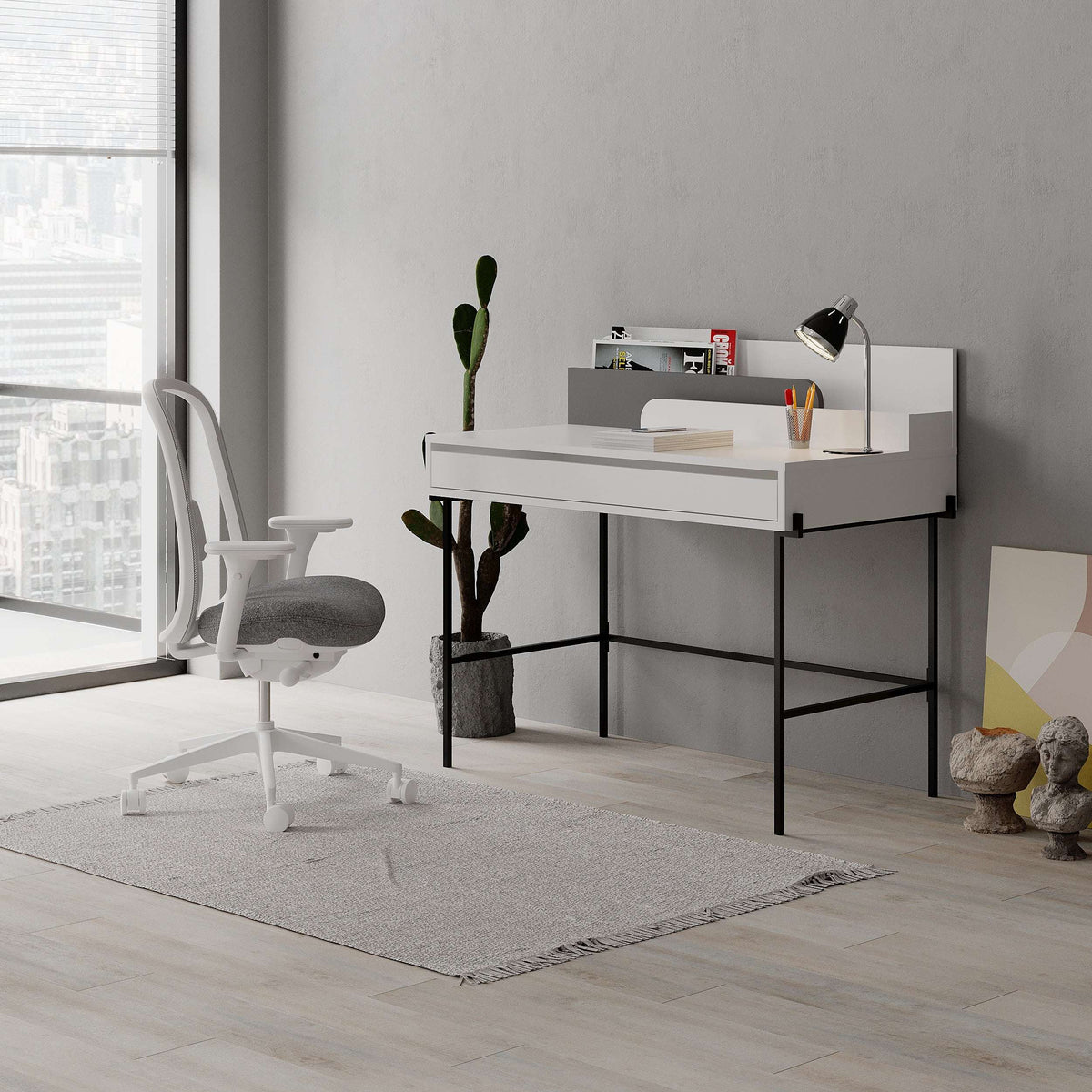 Modern study desk with white top, anthracite base, open cubby shelves, and drawer