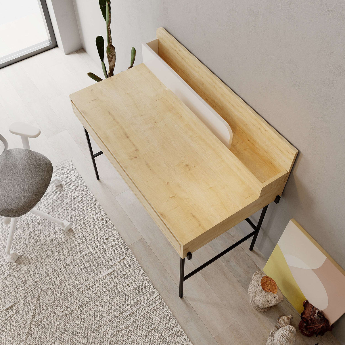 Corner view of modern desk with light wood top and black metal frame legs