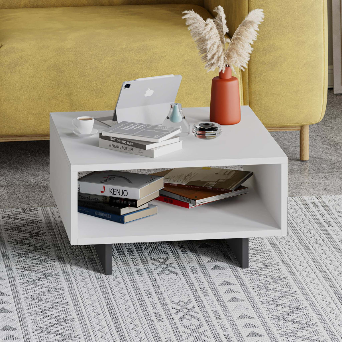 Modern coffee table in white with open center shelf and square legs