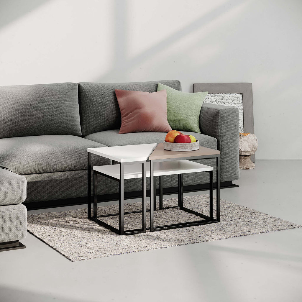 Modern coffee table with white top and black metal frame, styling on a rug