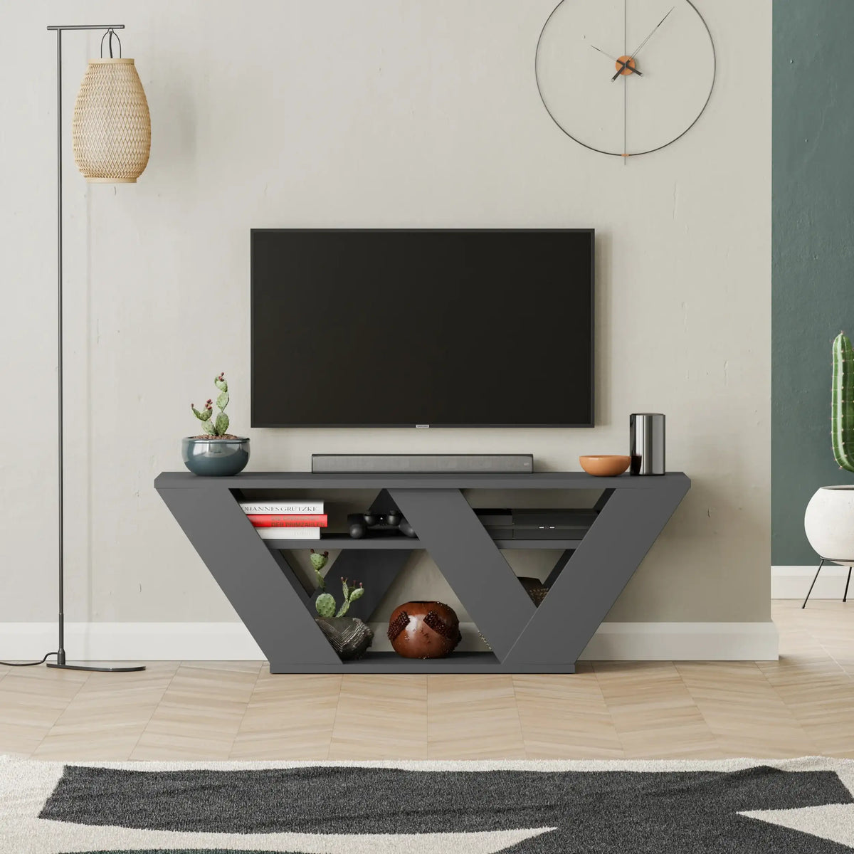 Modern dark gray TV stand with triangular open shelves and media compartments