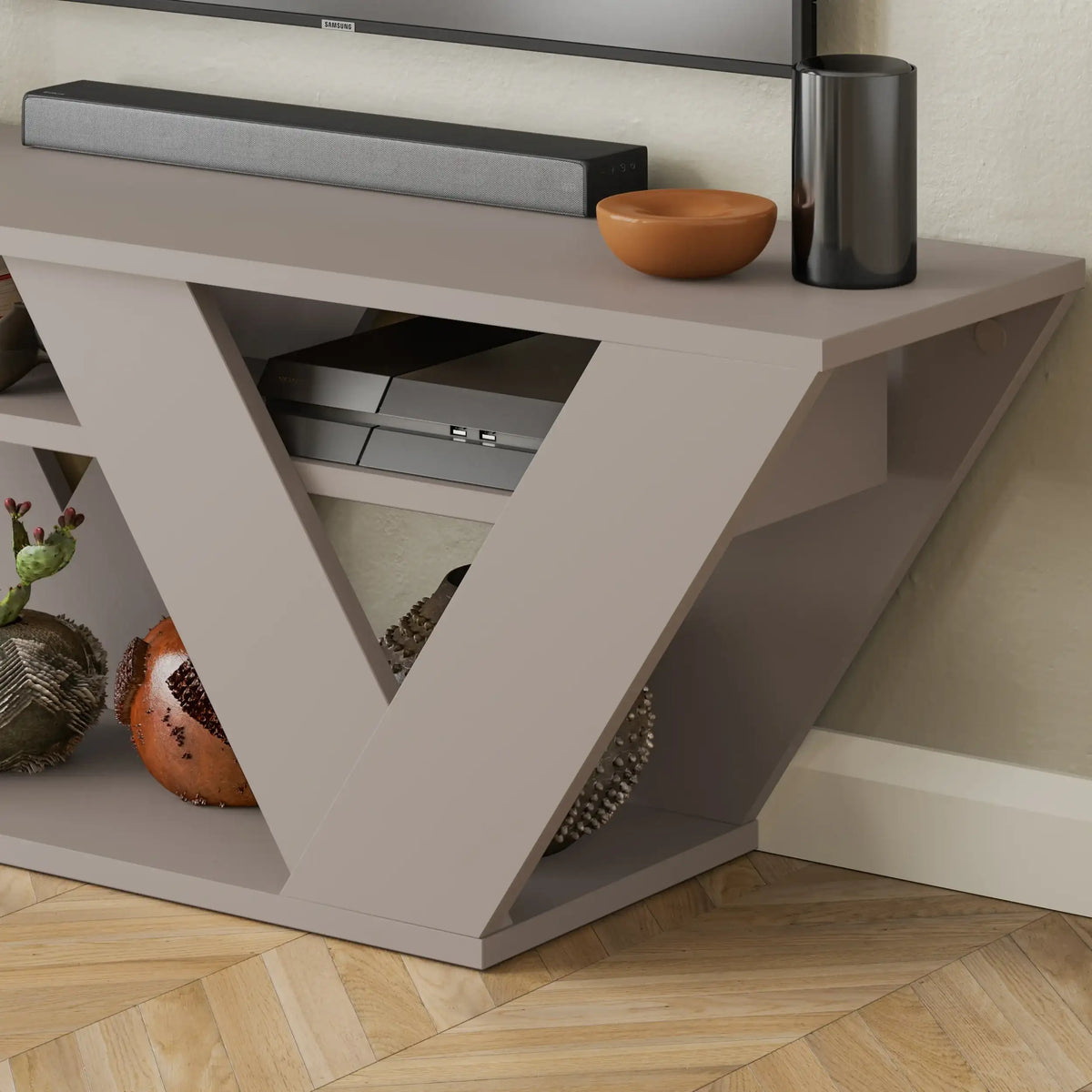 Grey TV stand close-up showing open V shelf and drawer