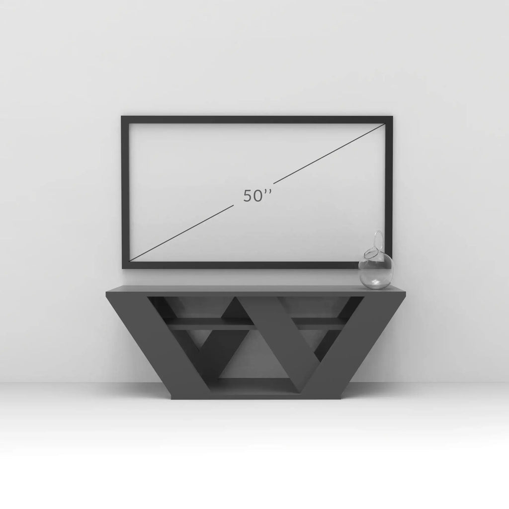 Dark gray TV stand with geometric triangular cutouts and low media drawer