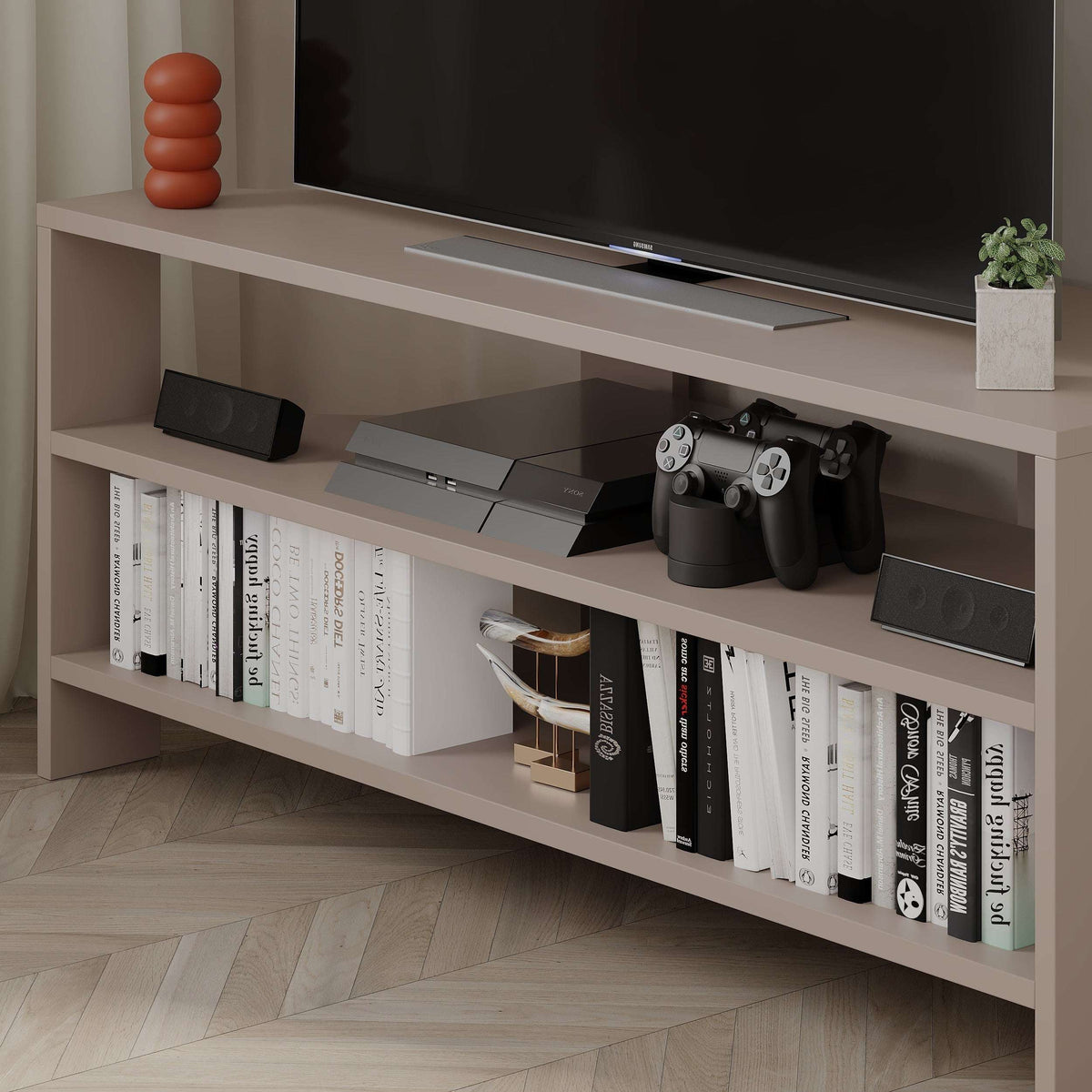 White TV console with open shelves and gaming console on the top ledge