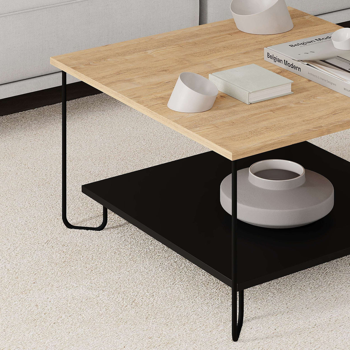 Two-tier coffee table with light oak top, black lower shelf, and black metal legs
