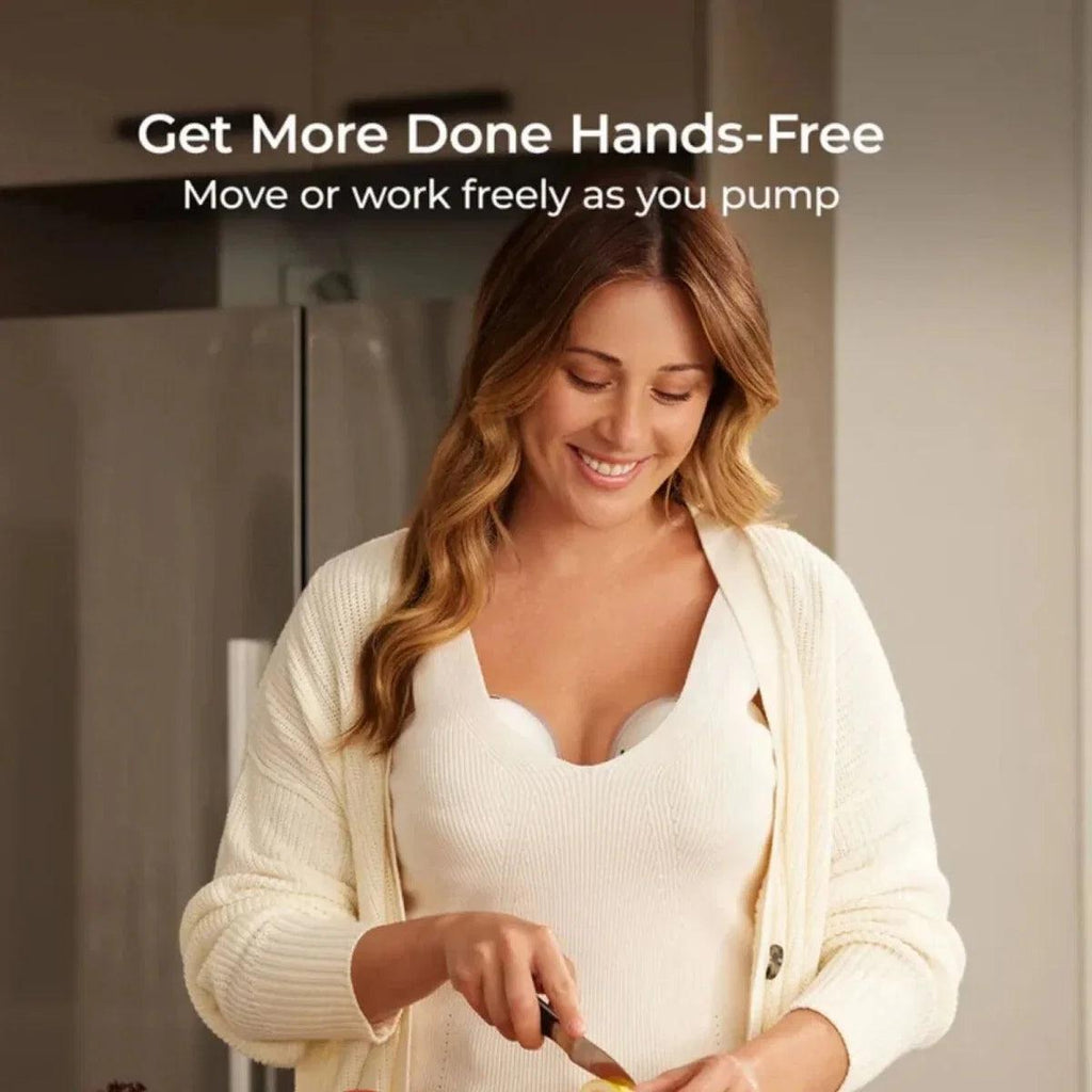 Woman wearing wearable breast pump cups while holding the control device