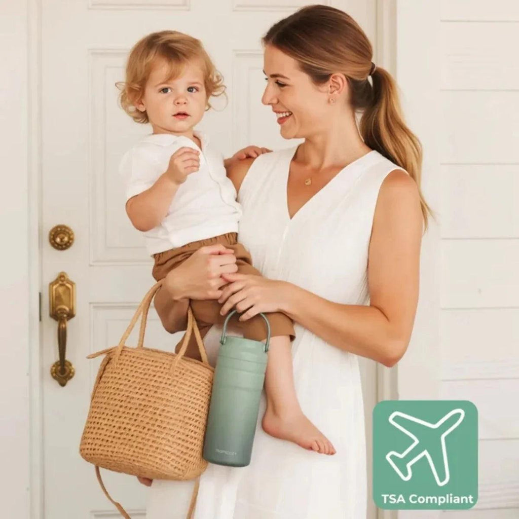 TSA-compliant breast milk cooler bottle, mint green, held in hand