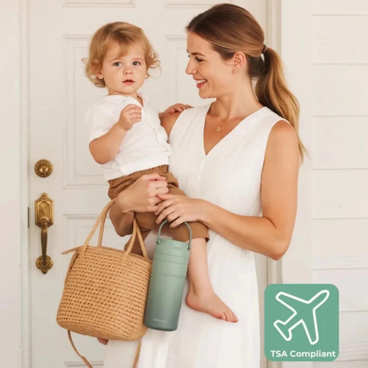 TSA-compliant breast milk cooler bottle, mint green, held in hand