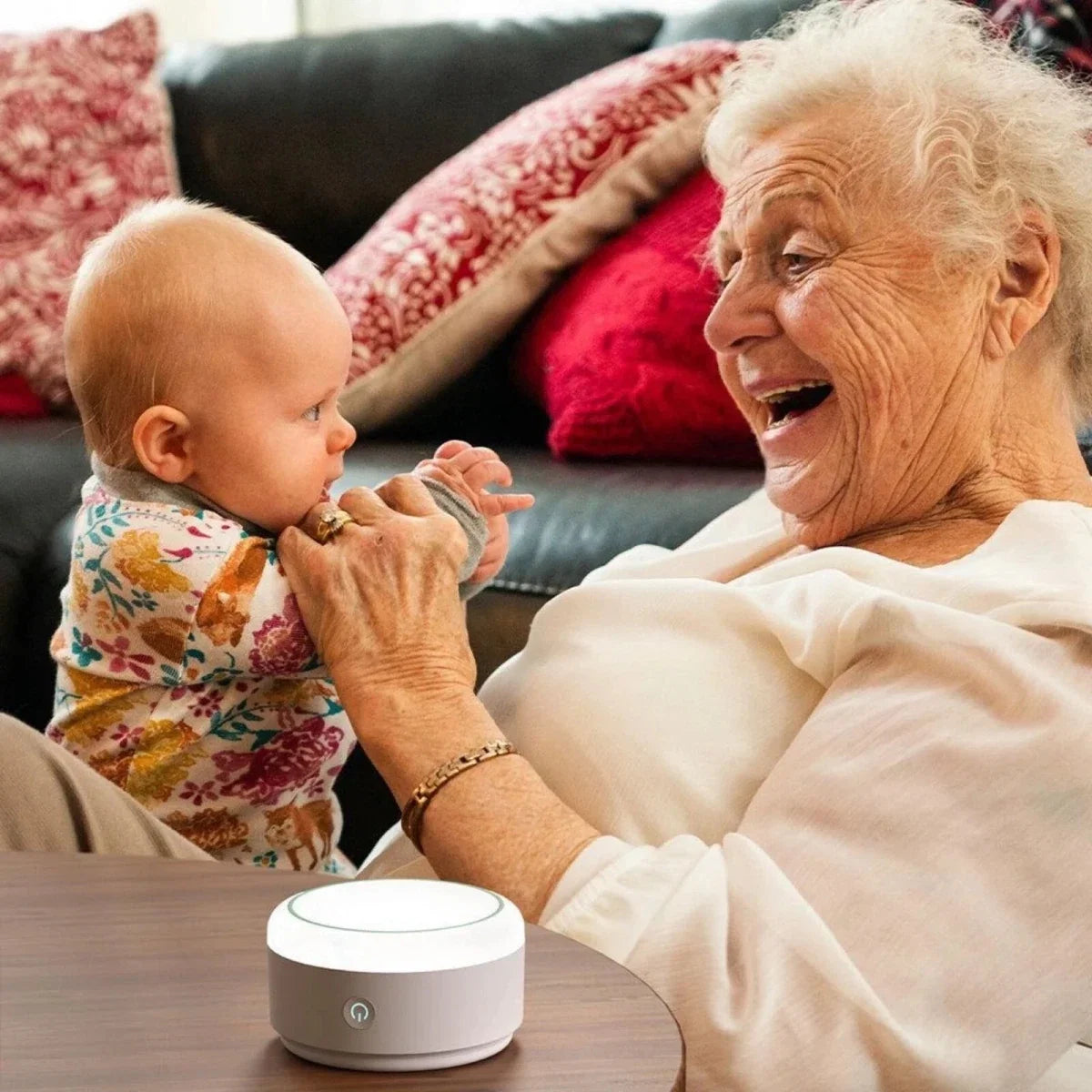 White Momcozy white noise machine on a table, round top with lighted control area