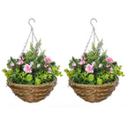Set of two hanging rattan planters with pink flowers and green leaves