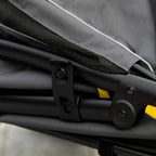 Grey stroller cover strap and buckle hardware with yellow accent