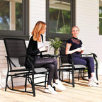Black patio gliding armchairs with square glass-top side table, outdoor seating set