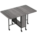 Grey drop-leaf dining table with black legs and caster wheels, compact folded top