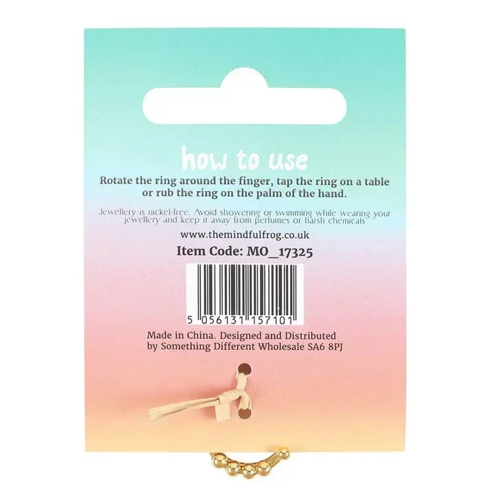 Gold tone anti-anxiety fidget ring shown on back of instruction card
