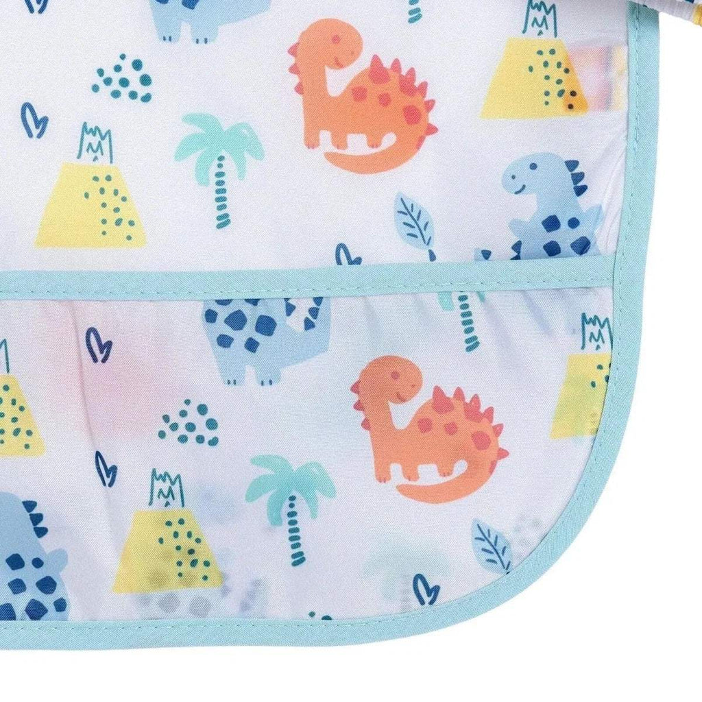 Close-up of baby coverall bib hem with light blue piping and colorful dinosaur print