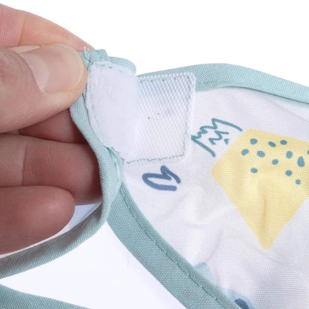 Baby coverall bib neck closure with visible stitching and light blue binding