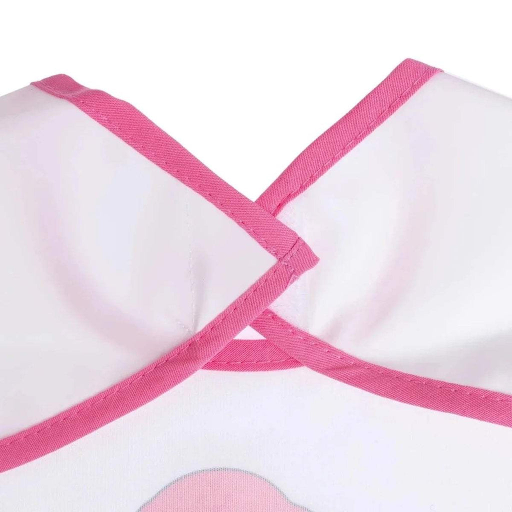 Close-up of pink cross-back straps on white short-sleeve bib.