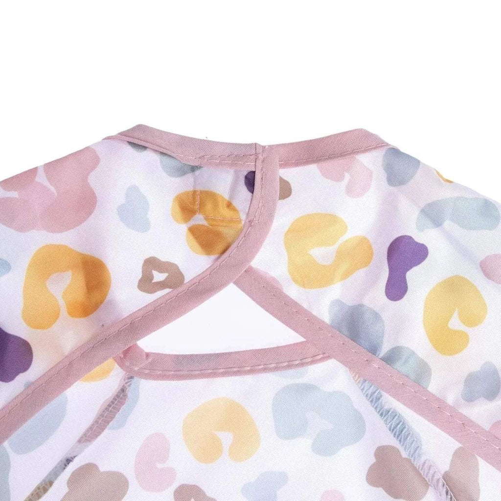 Baby coverall bib neck opening with pink trim and crossed straps, multicolor fabric