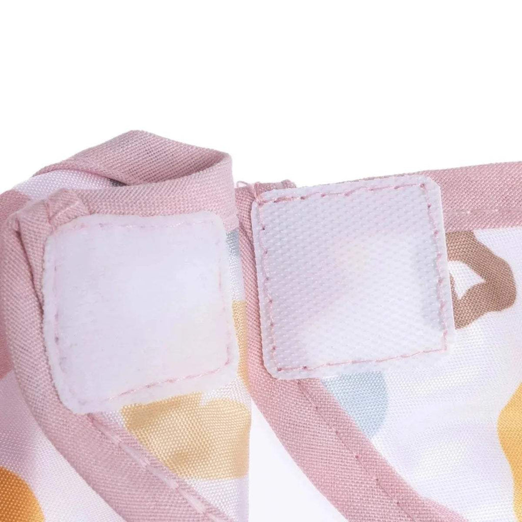Baby coverall bib fabric label close-up with pink-stitched rectangular panels