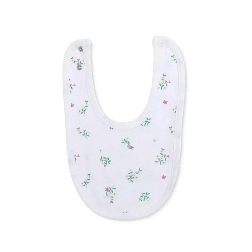White baby bib with scattered small floral illustrations in green and pink tones.
