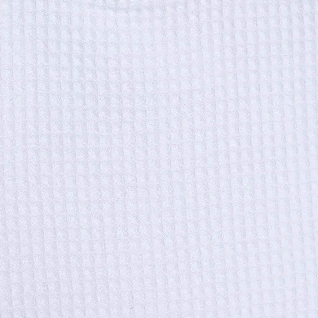 Close-up of white waffle-textured baby bib fabric